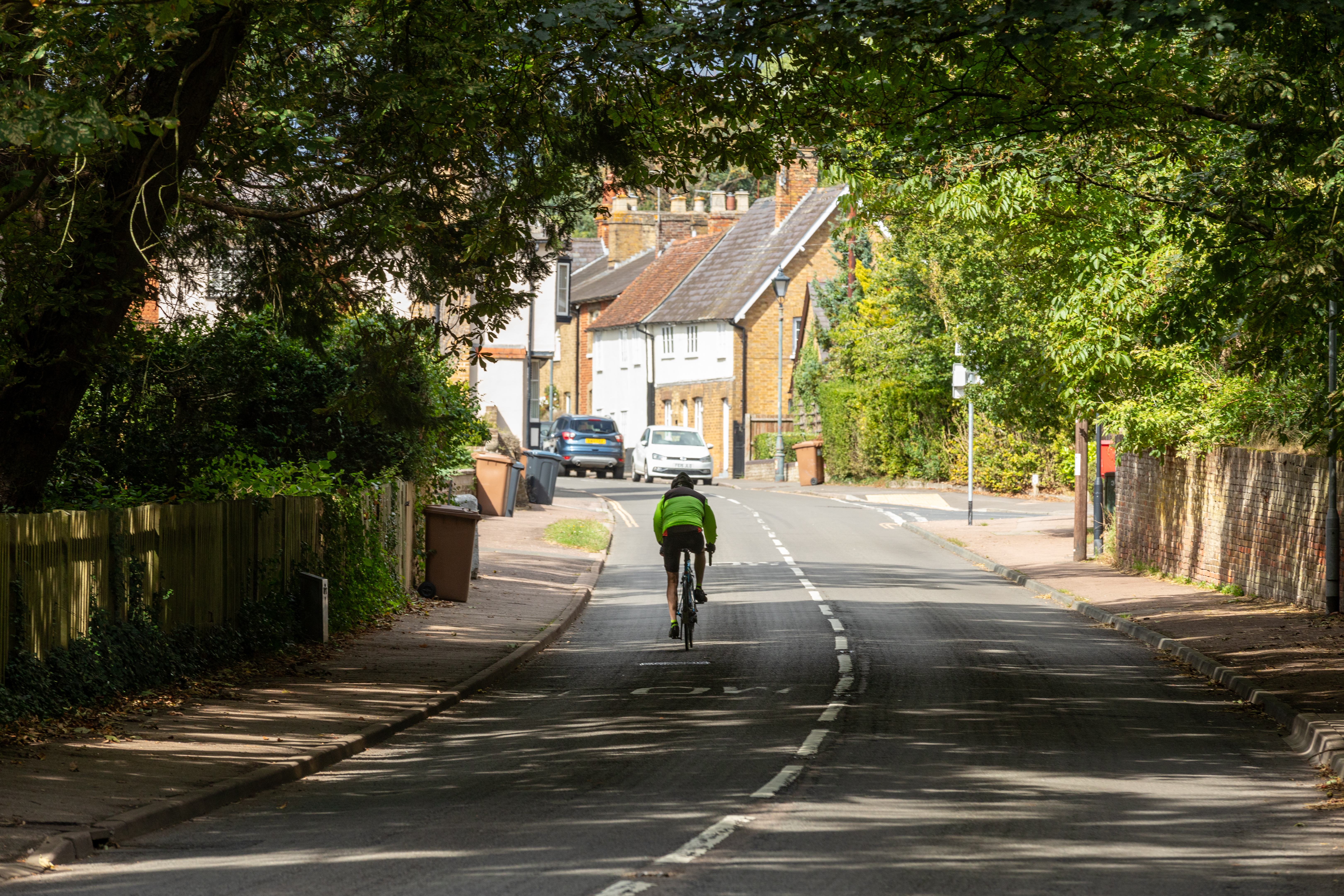 the back of a cyclist along a road in Watton-at-Stone