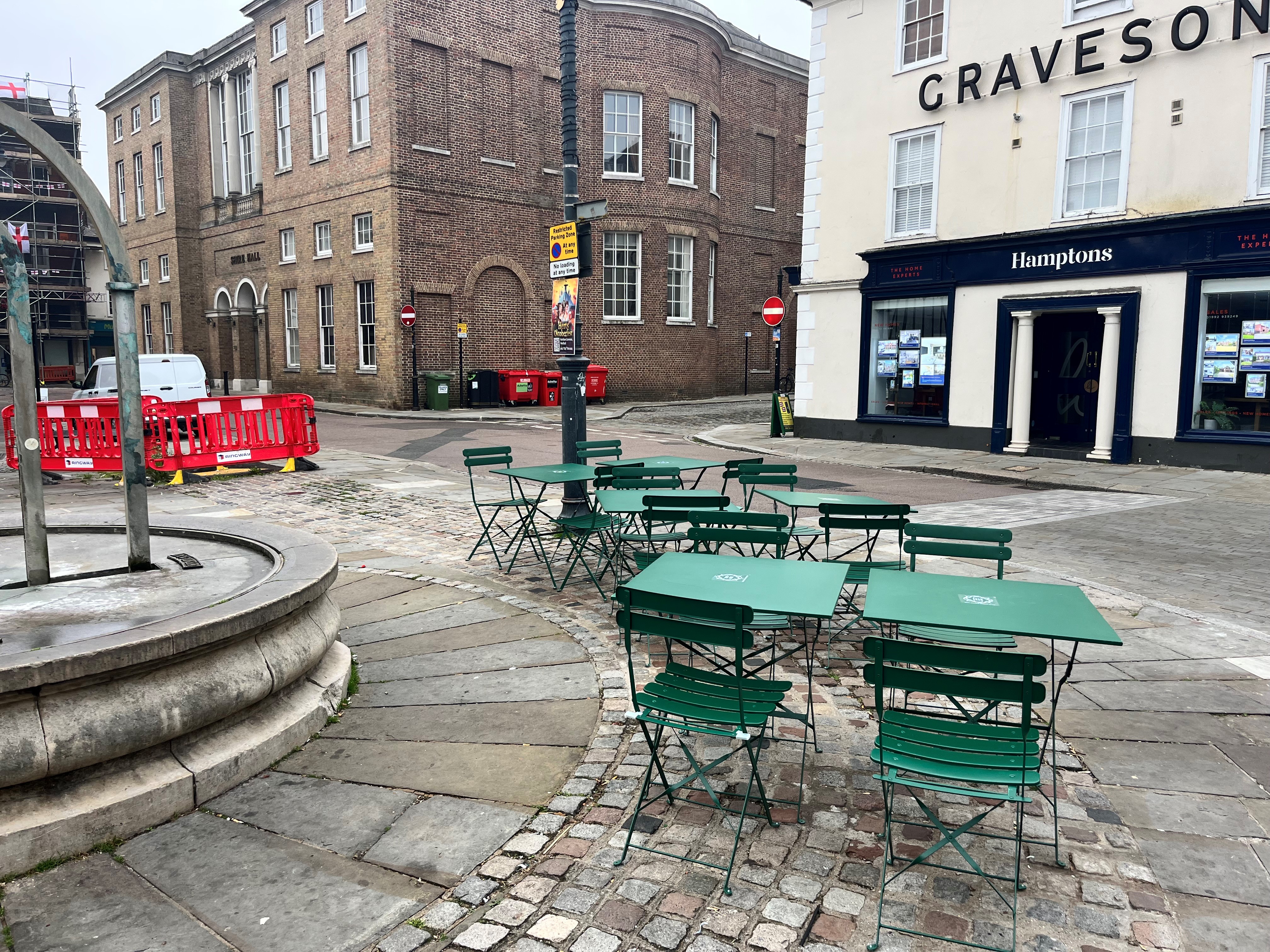 Tables and chairs positioned on the pavement opposite Brew Garden, Hertford