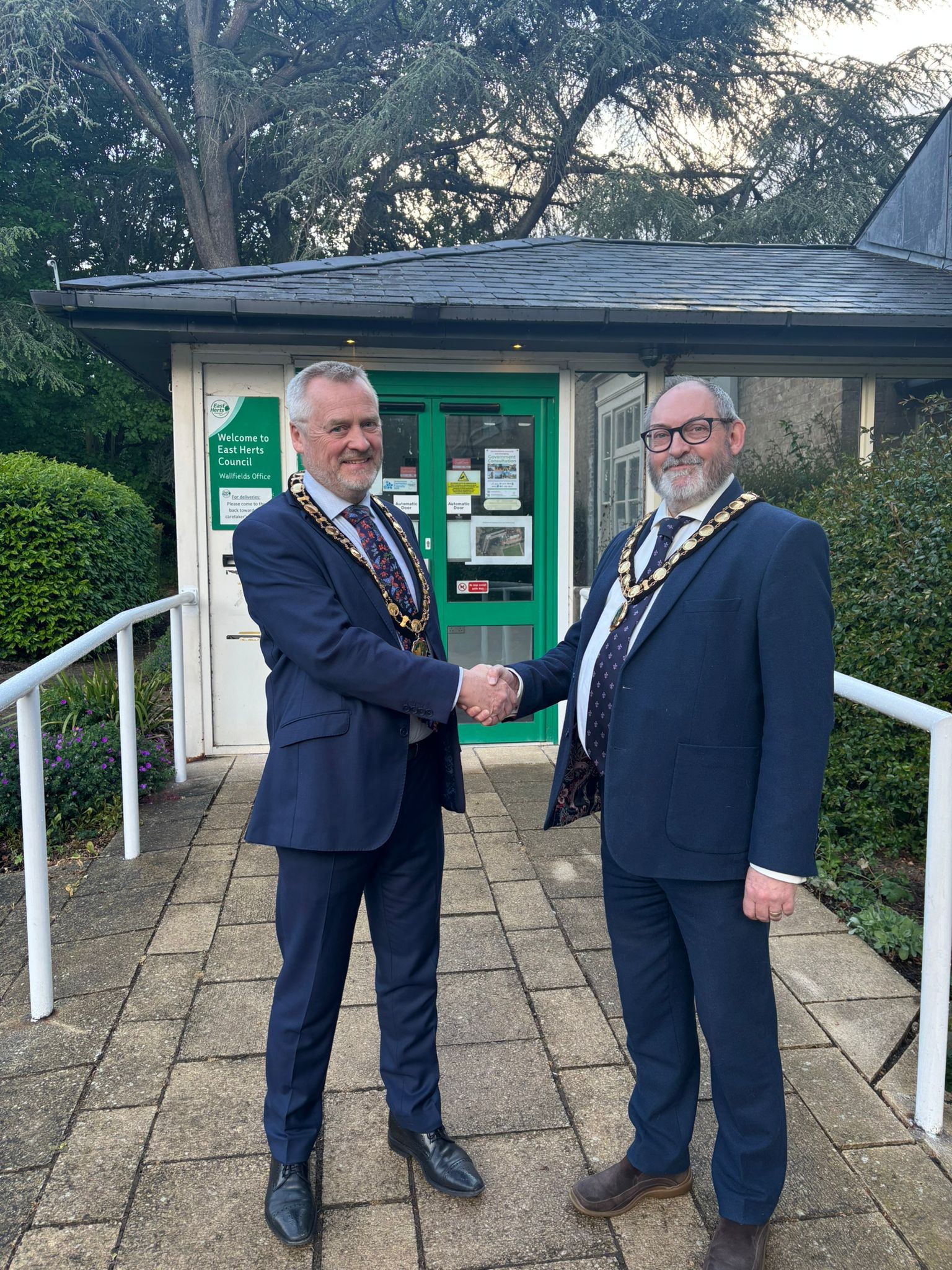 Councillor John Dunlop shaking hands with Councillor Martin Adams
