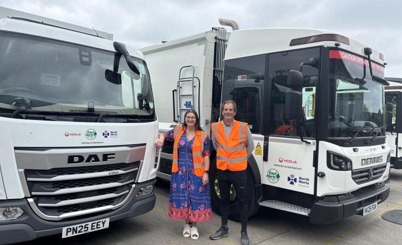 Cllrs Amy Allen and Tim Hoskin in front of new bin lorries as part of our new shared waste contract with North Herts