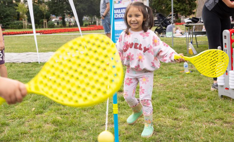 Little girl playing swing ball
