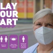 Cllr wearing a face covering with 'Play your Part' logo in purple