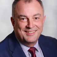 headshot of councillor Peter Boylan smiling in a suit