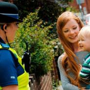 Police officer talking to mum and small toddler