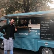 Man doing thumbs up in front of mobile food van