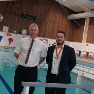 photo of Eric Buckmaster (left) and Paul Lindsey (right) stood next to the newly refurbished swimming pool at Hartham Leisure Centre