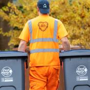 Collection crew carrying wheelie bins