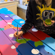 Artist painting a bench