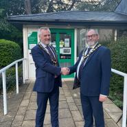 Councillor John Dunlop shaking hands with Councillor Martin Adams