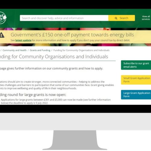graphic that shows a computer monitor which has the community grant funding page open on the East Herts website