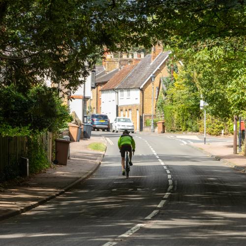 the back of a cyclist along a road in Watton-at-Stone