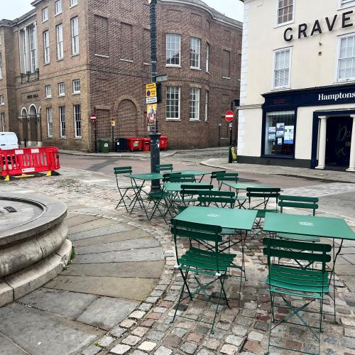 Tables and chairs positioned on the pavement opposite Brew Garden, Hertford